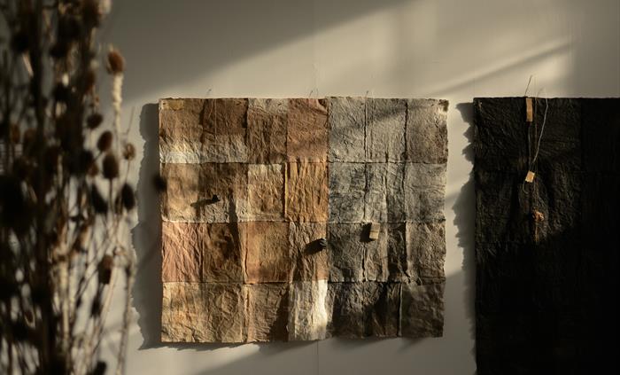 A patchwork paper installation by Jane Ponsford, made using collected materials from walk around Wales.